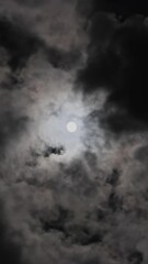 Wall Mural - full moon moving between clouds. vertical video
