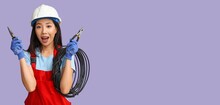 Asian Female Electrician Holding Pliers And Cable On Lilac Background With Space For Text