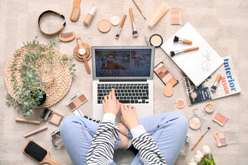 Poster - Woman with laptop, makeup products and accessories shopping online on beige carpet