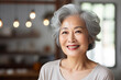 portrait of a smiling senior asian woman at home