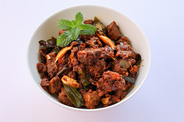 Canvas Print - Kerala style beef or Mutton dry fry. delicious spicy Beef fry in clay pot . beef curry for ghee rice, kappa, appam, parotta, puttu, bread and chappathi, beef roast. Indian cuisine .