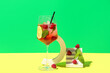 canvas print picture - Glass of fresh raspberry mojito and decorative podium with berries on colorful background
