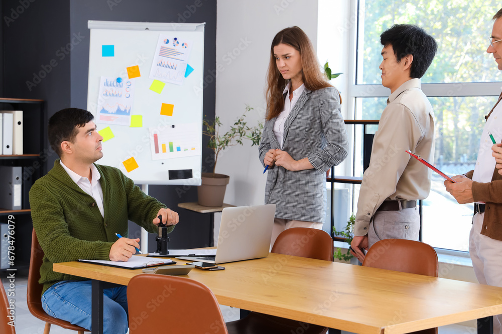 Group of business people working at table in office