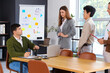 © Pixel-Shot - Group of business people working at table in office