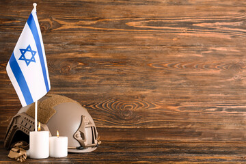 Wall Mural - Flag of Israel with military helmet and burning candles on wooden table