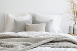 Fototapeta  - Close up of pillows and bed in background of cosy modern bedroom. The mockup concept of sleek and minimalist.