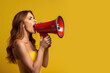 © piai - Side view of a woman shouting into a loudspeaker