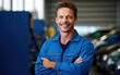 Smiling auto mechanic on a simple bright color background