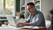 © yj - Focused male adviser working financial reports online over laptop at desk in home office. generative AI
