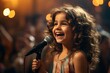 © sirisakboakaew - charming girl child singing emotionally at a concert in front of a microphone,