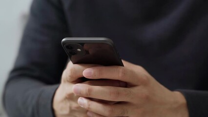 The man is using a smartphone for communication, internet, social networking, and online shopping. Technology concept.