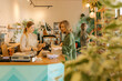 © Westend61 - Customer paying to owner at checkout counter in store