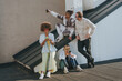 © Westend61 - Happy friends taking selfie and using smart phones on rooftop