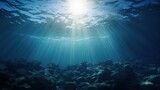 Fototapeta Do akwarium - blue gentle waves The ocean surface is visible from underwater rays of sunlight penetrating through it.