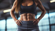 Close-up of a young woman's athletic belly in stylish sportswear. Losing weight and burning fat in the gym