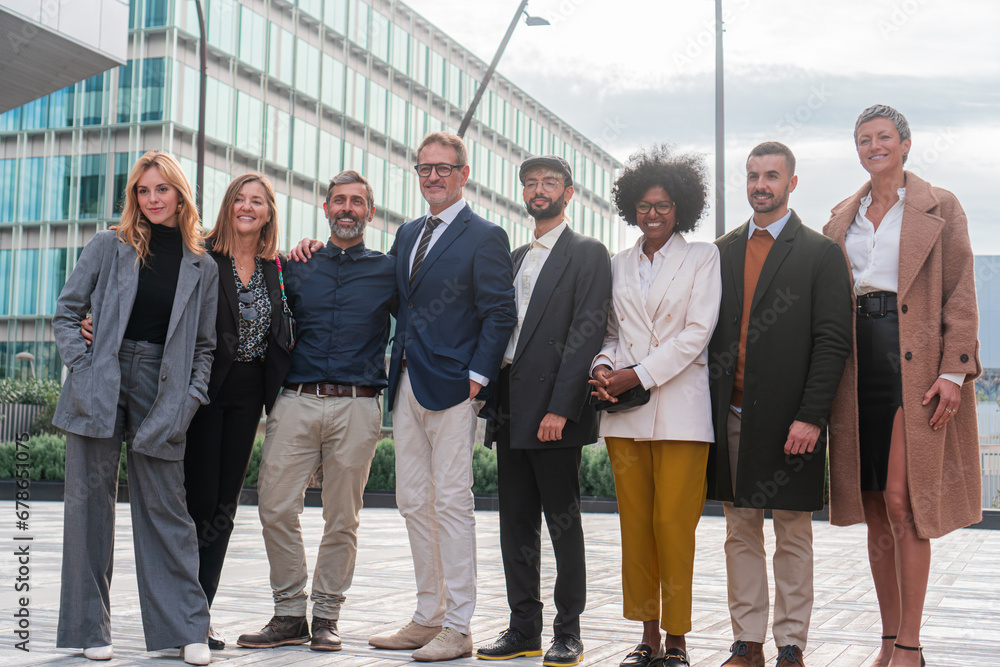 Portrait of smiling businesspeople posing for a group photo, standing ...