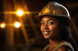 portrait of a young african woman miner in protective clothing looks at the camera on the background of a coal mine.