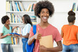 © Daniel Ernst - Group of african american students at library with successful black male student in front