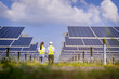 © Panumas - Electrical, instrument technician survey, checking, maintenance electric system at solar panel field in sunny day.