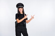 Photo of cheerful cute young policewoman dressed black clothes headwear pointing fingers empty space isolated white color background