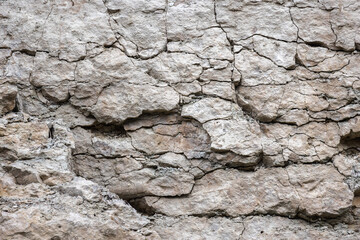 Wall Mural - Rough gray rock wall, natural stone background texture