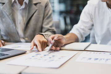 Colleagues working on paperwork in the office. Businessperson discussing the analysis of financial and accounting business reports.