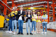 © krongthip - A team of engineers and employees wearing safety helmets smile.