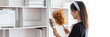 © Puwasit Inyavileart - Housewife holding a dusting brush to clean things Pillows, rugs and other things in the living room, Big cleaning, Daily routine, Clean up on weekends.