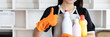 © Puwasit Inyavileart - Beautiful Asian housewife wearing apron and cleaning gloves prepares to clean her house, Housework, Daily routine, Big cleaning, Deep stain remover, Clean up on weekends.