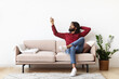 © Prostock-studio - Satisfied Indian man holding remote control relaxing under air conditioner