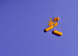 Opened orange pills on violet background