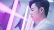 © DesignVectX - An Asian man with a purple light illuminating his face.
