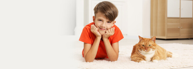 Poster - Little boy and cute ginger cat on soft carpet at home. Banner design with space for text