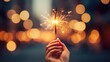 A hand holding a lit sparkler, bursting against a dark bokeh backdrop in the night, creating a vintage and dark-toned atmosphere for a celebration event or party.