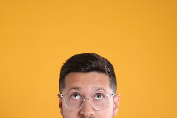 Poster - Man in stylish glasses on yellow background, closeup