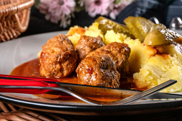 Poster - Meatballs pork and mashed potatoes topped with paprika gravy.