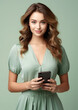 © Julia Zarubina - beautiful woman in a dress holds a mobile phone in her hands and looks at the viewer on a color background, girl with a smartphone, online shopping, portrait, business, lady, screen, device, internet