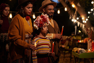 Wall Mural - Family with candles standing at altar and celebrating the holiday