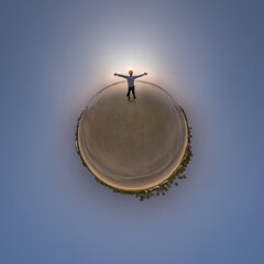 Wall Mural - tiny planet in blue sky with happy man joyfully stands on seashore in rays of evening tropical sun with transformation of spherical panorama 360 degrees. Curvature of space.