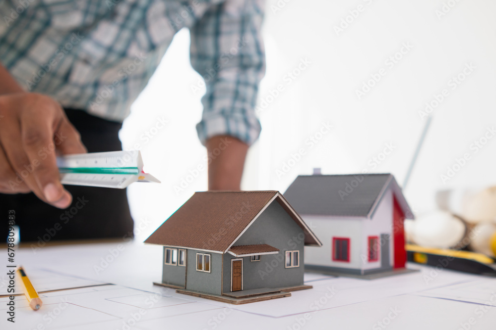 Setting Up Model Building Workplace Building models and blueprints are placed on work desks in the ...