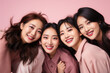© Valeriia - Asian female friends taking selfie smiling at camera on pink background. Laughing young women celebrating having fun together. Portrait student girls enjoying vacation. Female power feminists concept