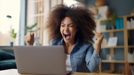 Ecstatic African American woman celebrates online job success.