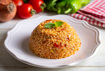 Traditional turkish bulgur pilaf with tomato sause in plate (Turkish name; meyhane pilavi)