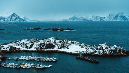 Small fishing village with boats among norwegian sea