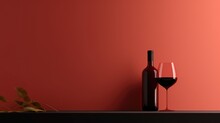 A Glass Of Red Wine And Bottle On Red Background