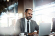 © Davor - Businessman sitting in modern cafe working on laptop