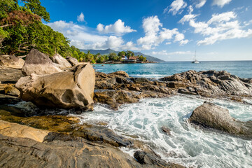 Tropical landscape with palm trees and granite rocks. Sunset beach at Seychelles, Mahe