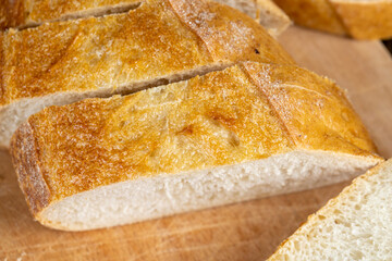 Wall Mural - wheat loaf of bread close-up on the table