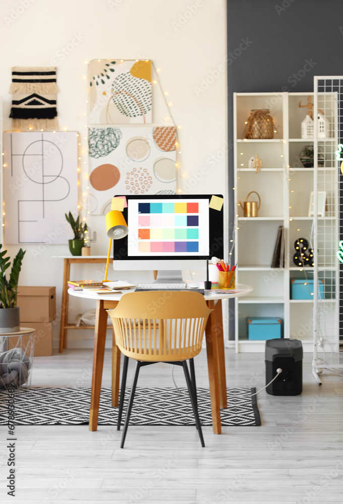 Graphic designer's workplace with computer in interior of office