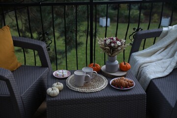 Canvas Print - Rest on terrace with rattan furniture. Drink, dessert and autumn decor on table